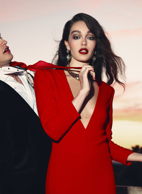 Woman in a red dress being provocive and wearing perfume